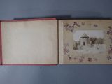 an open book with a picture of a house in the background