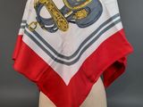 a close up of a white and red scarf on a mannequin head