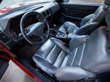 a red car with black leather seats and a steering wheel