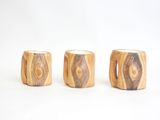 three wooden stools sitting next to each other on a white surface