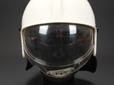 a close up of a helmet on a stand on a black background