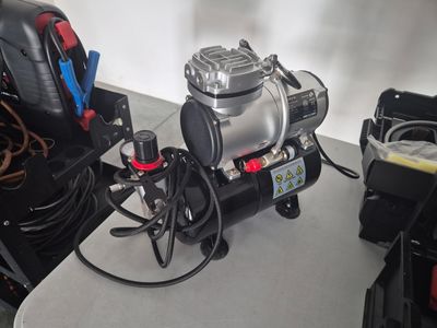 a small air compressor sitting on top of a table