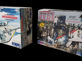 two boxes of star wars toys on a black background