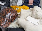 a pile of clothing that is sitting on a table