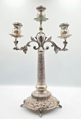 silver plated candelabra with three candles on a stand