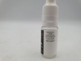 a small bottle of liquid sitting on a table
