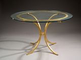 an image of a glass table with gold metal legs and a glass top