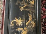 a picture of a black and gold oriental painting on a rug