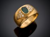 a close up of a gold ring with a green stone and diamonds