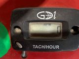 a close up of a tach hour on a red table