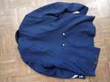 a blue jacket laying on the floor on the floor