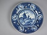 a blue and white plate with a windmill on it