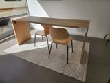 two chairs and a table in the corner of a room