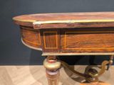 a small table with a wooden top on a wooden floor