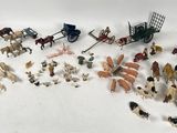 a lot of small toy animals and horses on the table
