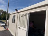 a woman standing in the open door of a mobile home