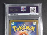 the pokemon card is in a plastic holder on a table
