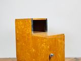 un petit meuble en bois surmonté d'un tiroir
