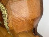 a wooden table with a marble top on a hard wood floor