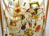 a scarf hanging on a chair with a painting on it