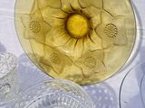 a yellow glass bowl with a yellow flower in it