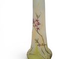yellow glass vase with pink flowers on it on a white background