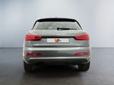 the rear end of a silver car with a license plate on it