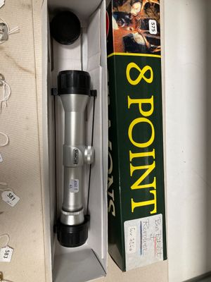 a silver and black coffee maker in a box