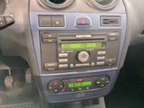 a car dashboard with a radio and a clock on it
