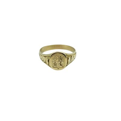 a gold signet ring with a cross on the front of it
