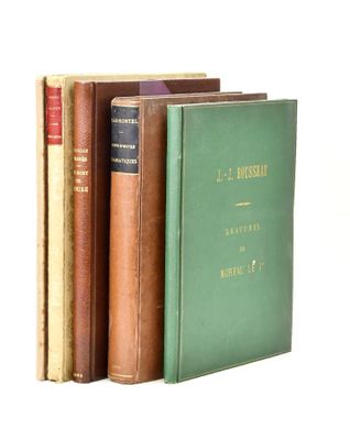 several books are stacked on top of each other on a white surface