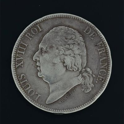 a close up of a coin on a black surface