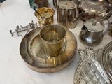a table that has a lot of silver items on it