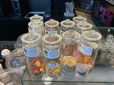 many jars of different kinds of food on the counter