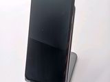 a cell phone that is sitting on top of a stand