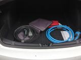 the trunk of a white car with a bunch of electronics in it