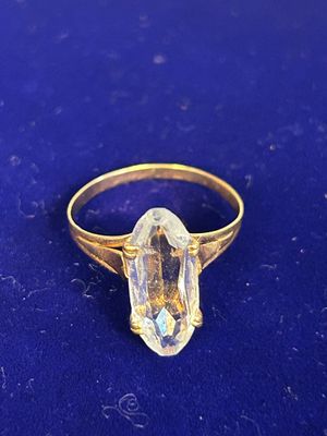 an image of a gold ring with a clear quartz stone on it