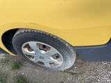 a yellow car that is parked on the side of the road