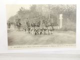 a black and white photo of a group of people riding horses