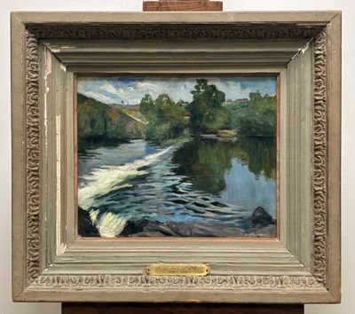 an oil painting of a river in a frame on a wooden stand