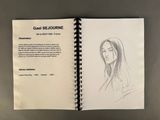 an open book with a drawing of a woman ' s face on it