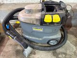 a vacuum that is sitting on the concrete floor