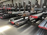 many steel beams in a warehouse with a lot of them