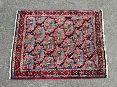 a red and blue rug on the ground