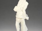 an ivory figurine of a man carrying a bag