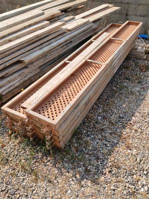 several pieces of wood are stacked on top of each other in a pile