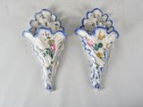 pair of blue and white wall sconces with flowers and leaves
