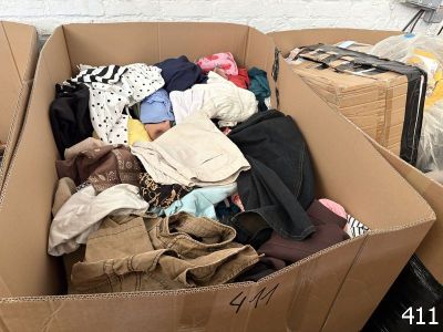 a cardboard box filled with clothes and other items