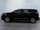 a black suv is parked in a large room with a white wall