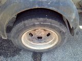 a close up of a flat tire on a truck